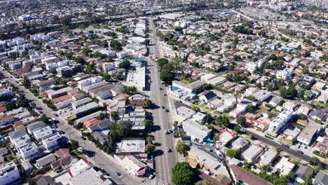 Los-Angeles-CA-USA,-Aerial-View-of-Mid-City-Neighborhood-on-Hot-Sunny-Day,-Street-Traffic-and-Buildings