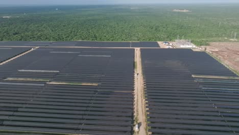 Aerial-view-backwards-over-solar-cells,-in-sunny-La-Romana,-Dominican-Republic