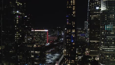 Downtown-Los-Angeles-California-USA,-Aerial-View-of-Night-Traffic-Between-Skyscrapers-and-Towers