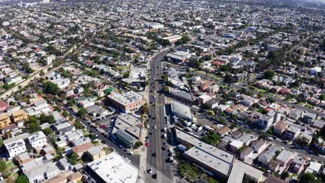 Revealing-Aerial-View-of-Los-Angeles-CA-Cityscape-Skyline-From-Mid-City-Residential-Neighborhood,-Drone-Shot