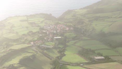 Flying-through-clouds-at-Mosteiro-viilage-at-Flores-Azores,-aerial