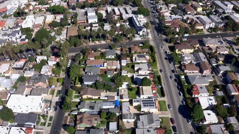 Mid-City,-Los-Angeles-CA-USA,-Drone-Shot-of-Residential-Neighborhood,-Homes-and-Street-Traffic-on-Hot-Sunny-Day