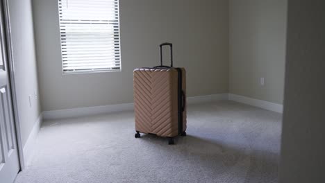 Entering-a-sunny-empty-room-with-one-bag-of-luggage