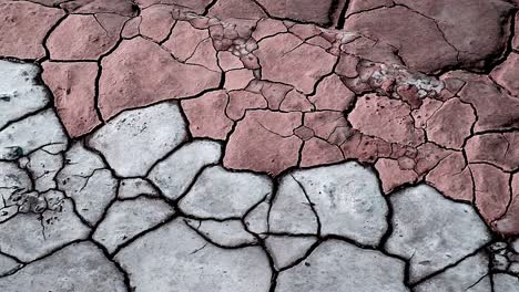 Geometric-patterns-on-the-earth-of-a-dried-up-river-bed-with-different-shades-of-brown-and-grey-creating-an-interesting-scene-of-natural-colors-and-textures