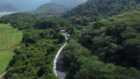 Drone-shot-of-Pollachi-To-Valparai-scenic-route-road-trip-near-Aliyar-Reservoir-and-Dam,-Coimbatore,-Tamil-Nadu,-South-India