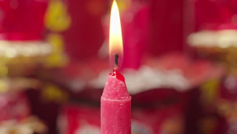 Person-lighting-a-red-Chinese-candle-with-a-match