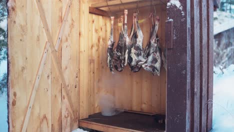 Roe-Deer-Meat-Hanging-Inside-Smokehouse-For-Traditional-Cold-Smoking-In-Winter
