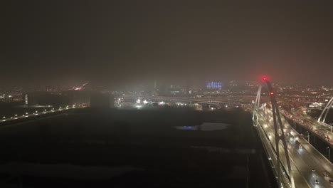 Dallas,-Texas-skyline-at-night-with-foggy-weather-and-drone-video-moving-up