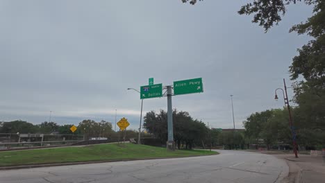 Walking-towards-I-45-exit-in-Houston,-Texas-on-a-cloudy-day