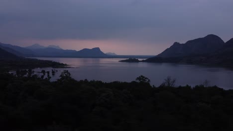 Panoramic-drone-shot-of-Palar-Dam-Reservoir-at-sunset-under-an-overcast-sky,-Tamil-Nadu,-India