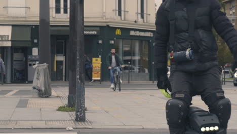 Slow-Motion-Shot-of-A-Man-Riding-A-Unicycle-Electric-Scooter,-Vincennes-France