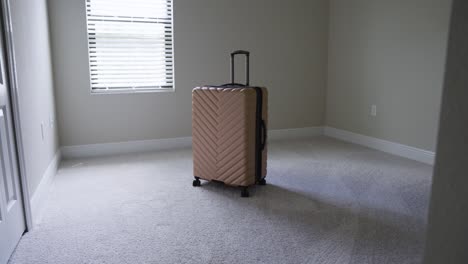 Slow-mo-of-entering-a-sunny-empty-room-with-just-a-bad-of-luggage