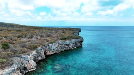 The-drone-is-flying-around-cliffs-above-the-ocean-in-Curacao-Aerial-Footage-4K