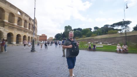 Rome-Immersive-POV:-Moving-In-Busy-Streets-to-Chiesa-Santi-Luca-e-Martina,-Italy,-Europe,-Walking,-Shaky,-4K-|-Colosseum-Exterior-Panorama-with-Tourists