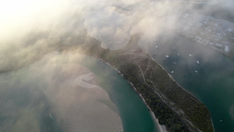 Aerial-View-Through-Clouds-Of-Noosa-Heads-Main-Beach-And-Noosa-Botanic-Gardens-In-Queensland,-Australia