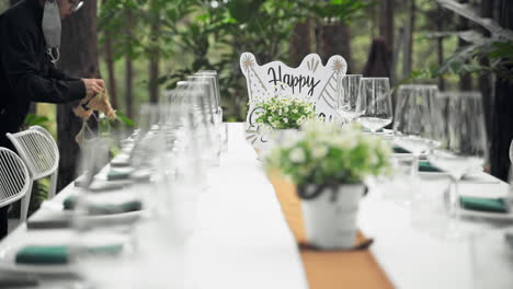 Birthday-party-banquet-being-prepared,-decoration-on-the-table-with-flower-and-glass