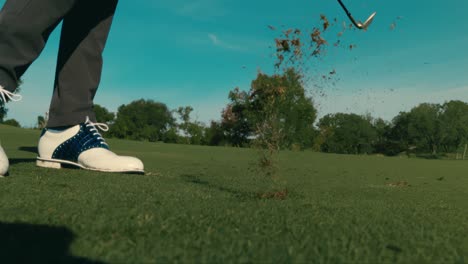 Slow-motion-golf-shot-from-side,-wedge-shot-from-clean-fairway-lie-on-sunny-day-in-4k-push-in