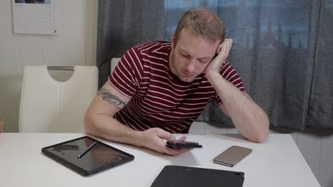 Man-is-surrounded-by-digital-gadgets-but-still-feeling-lonely