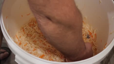 Pressing-sauerkraut-with-hand-fist