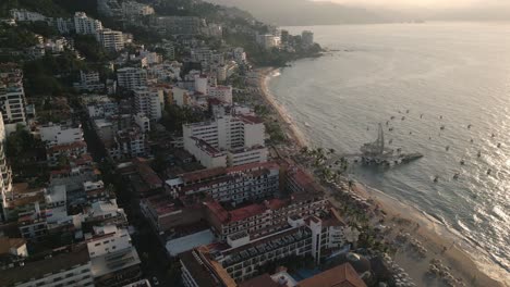 Aerial-Sunset-Beach-Water-Reflection-Above-Pier-of-Puerto-Vallarta-Mexico-Town