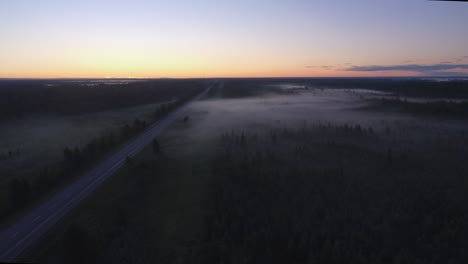 Drone-shot-of-thick-fog-blanketing-the-highway-in-the-early-morning-on-the-east-coast