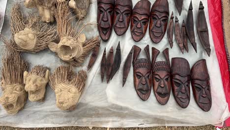 Handicraft-wooden-tribal-facemasks-at-a-roadside-stall-in-Purulia,-India