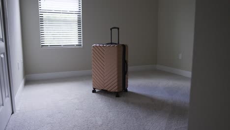 Entering-an-sunny-empty-room-with-just-a-bag-of-luggage