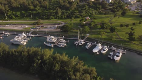 Orbit-drone-shot-of-yachts-parked-at-dock-of-American-Memorial-Park,-Saipan