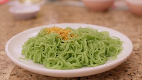 Detail-of-dish-with-green-pasta-and-seasoning