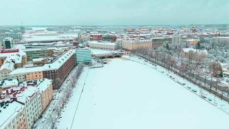 Aerial-wide-shot-of-Hakeniemi-district-in-Helsinki,-Finland-in-the-winter