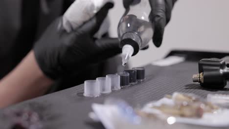 Dispensing-Ink-Into-the-Cap-for-Application-in-the-Tattooing-Process---Close-Up