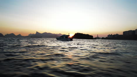 Filmischer-Blick-Auf-Eine-Yacht,-Die-Bei-Sonnenuntergang-Auf-Dem-Meer-Kreuzt,-Rio-De-Janeiro,-Brasilien