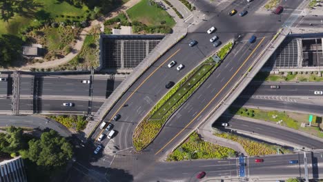 Aerial-Birds-Eye-View-Of-Traffic-Driving-Over-Avenue-Vitcaura-Overpass-In-Santiago