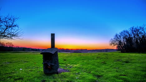 Birdhouse-in-a-countryside-meadow---golden-sunset-motion-time-lapse