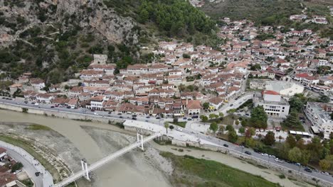 Aerial-bird-eye-view-of-Old-city-of-Berat-and-Osum-River-surrounded-by-mountains-and-hills,-Albania