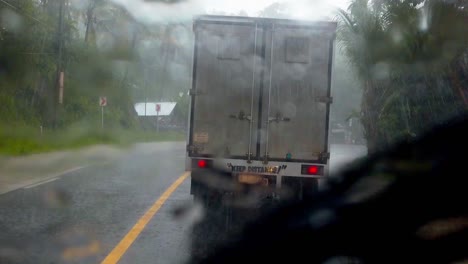 Torrential-monsoon-rain-in-Philippines,-following-truck-in-dangerous-conditions