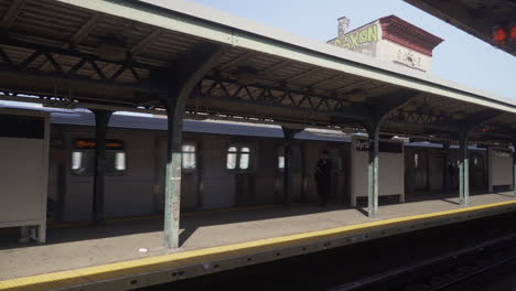 MTA-Train-arriving-at-platform-on-a-sunny-day