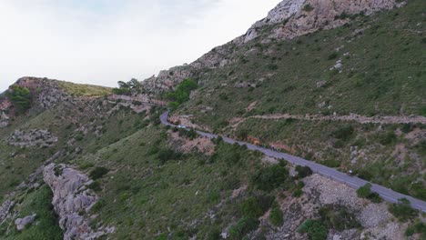 Aerial-Drone-Footage-Following-Bikers-Driving-On-Narrow-Winding-Road