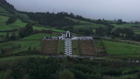 Wide-view-of-Ermida-de-Nossa-Senhora-da-Paz-chapel-On-Hill-Against-Cloudy-Sky---Azores,-Portugal