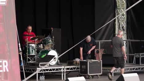 Staff-Testing-The-Drumkit-On-Stage-In-Trentham-Gardens,-With-Sound