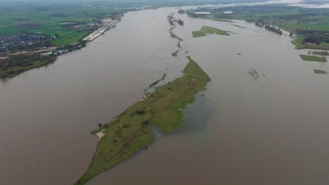 Aerial-view-of-teh-Waal-Rover-after-is-has-overrun-its-banks-near-Gorinchem,-just-outside-of-Rotterdam,-with-farms-and-local-communities-being-hit-with-devastating-flooding