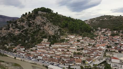 Panoramic-drone-shot-of-Old-city-of-Berat-and-Osum-River-surrounded-by-mountains-and-hills,-Albania