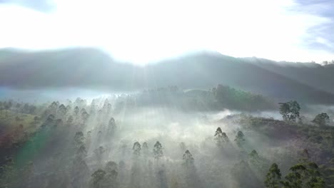 aerial-drone-shot-The-sun-rays-are-falling-behind-the-mountains-and-the-fog-on-the-hills-is-shining-and-looking-very-beautiful