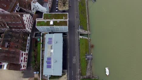 Drone-soars-over-Basel's-river-border,-revealing-stunning-riverside-houses