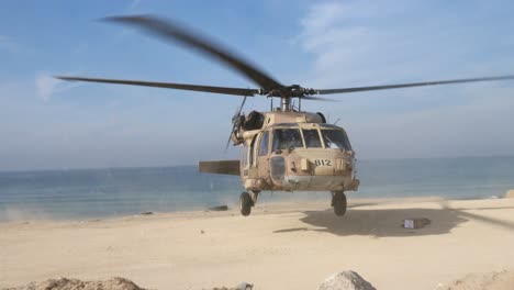 Israeli-combat-helicopter-takes-off-on-the-edge-of-the-sea-in-Gaza,-Palestine_close-shot