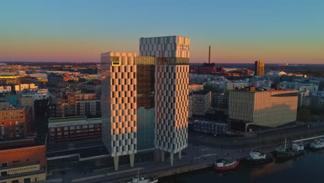 Clarion-Hotel-Helsinki-High-Rise-Building-at-Golden-Hour,-Jatkasaari,-West-Harbor,-Finland,-Aerial-unique-pov