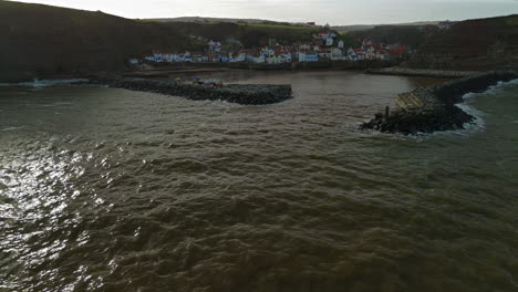 Low-Establishing-Drone-Shot-of-Staithes-and-Harbour-on-Sunny-Day-UK