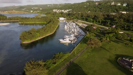 Pull-away-drone-shot-of-yachts-at-American-Memorial-Park,-Saipan