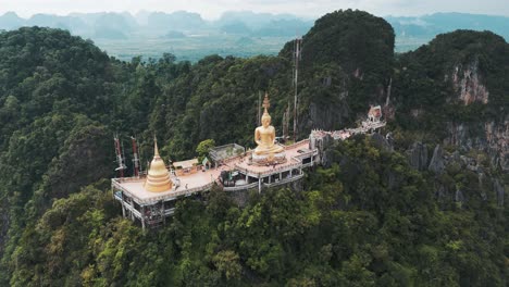 Aerial-orbiting-shot-of-Tiger-Cave-Temple-on-green-mountain-in-Krabi,-Thailand