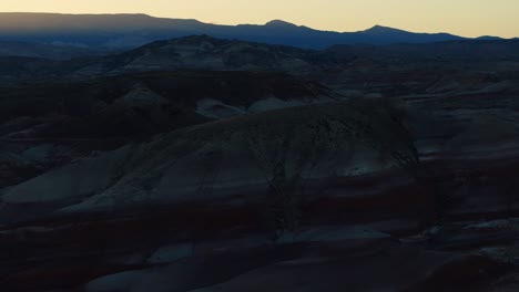 Slow-Aerial-Parallax-70mm-Shot-of-Bentonite-Hills-During-the-Sunset